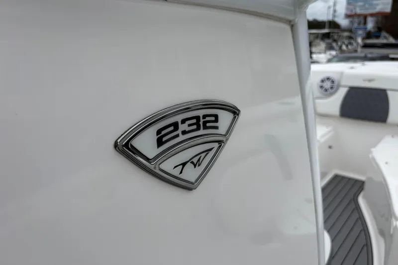 Slide: The Image of 2019 Tidewater 232 CC Adventure boat emblem on white surface. - 31