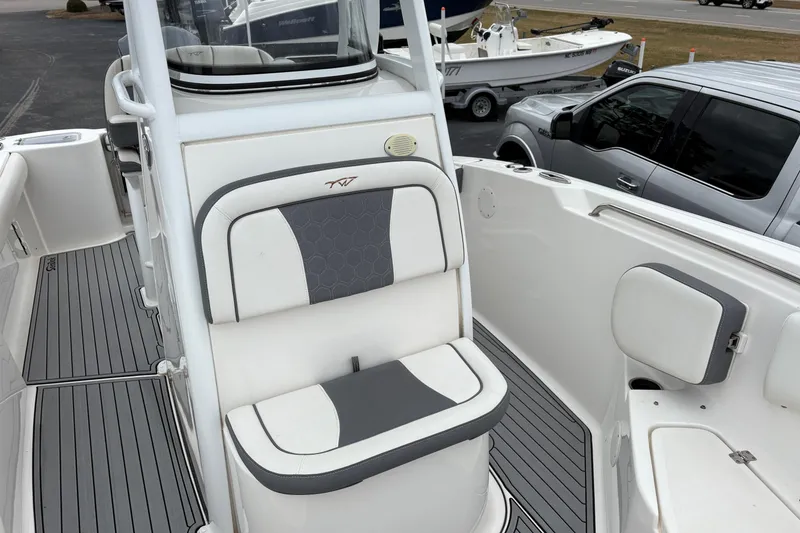 Slide: The Image of 2019 Tidewater 232 CC Adventure boat interior with cushioned seating and sleek design. - 9