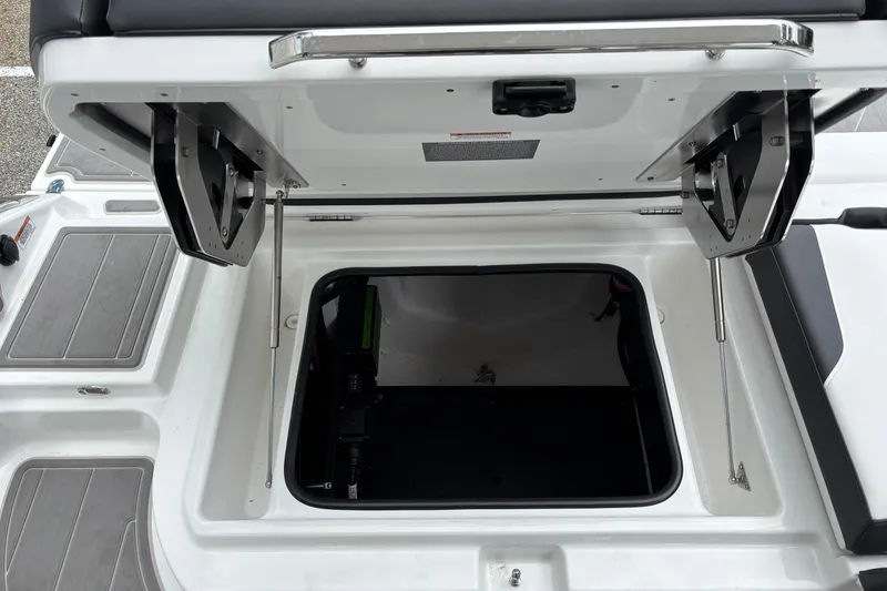 Slide: The Image of Open storage compartment on 2026 Monterey Elite 25 OB boat, showcasing interior space. - 17