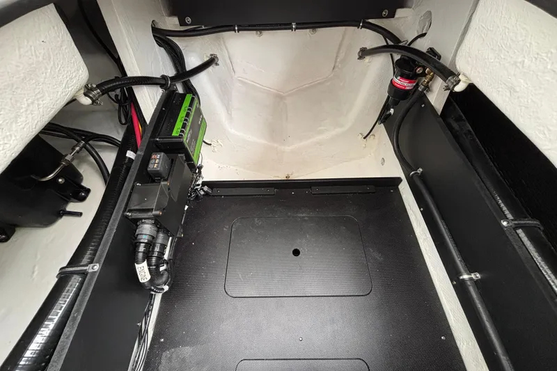 Slide: The Image of Engine compartment of 2026 Monterey Elite 25 OB boat, showcasing wiring and components. - 18