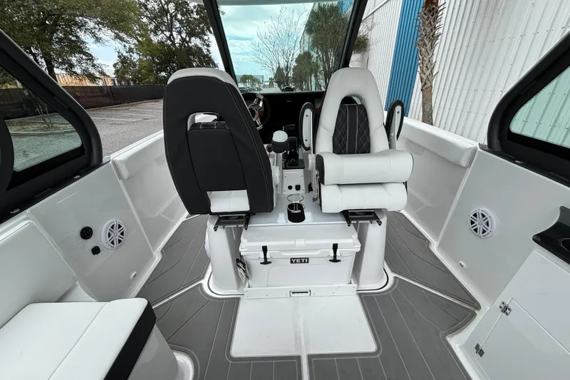 Slide: The Image of Interior of 2026 Monterey Elite 25 OB boat with modern seating and sleek design. - 19