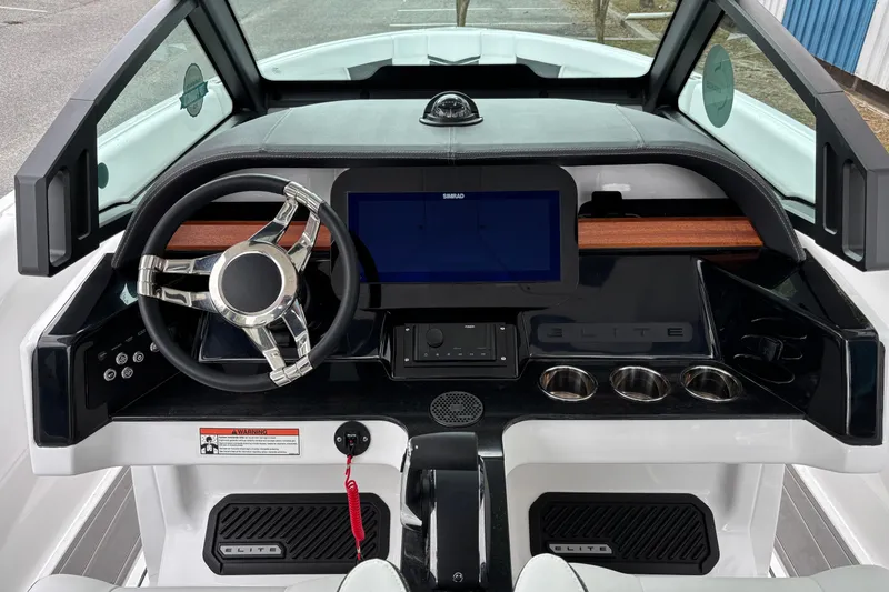 Slide: The Image of 2026 Monterey Elite 25 OB boat dashboard with steering wheel and digital display. - 23