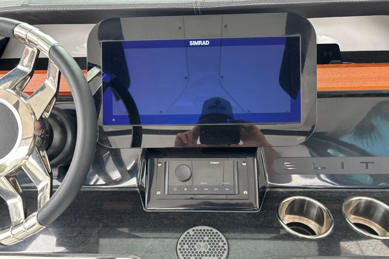 Slide: The Image of Dashboard of 2026 Monterey Elite 25 OB boat with Simrad display and steering wheel. - 25