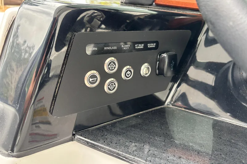 Slide: The Image of Control panel of 2026 Monterey Elite 25 OB boat with various function buttons. - 27