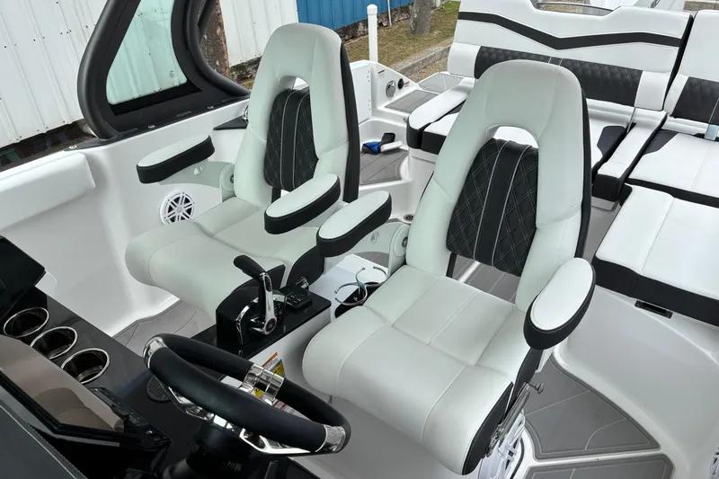 Slide: The Image of 2026 Monterey Elite 25 OB boat interior with luxurious seating and modern steering console. - 28