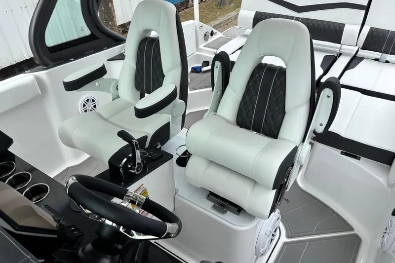 Slide: The Image of Luxury interior of 2026 Monterey Elite 25 OB boat with plush seating and modern controls. - 29