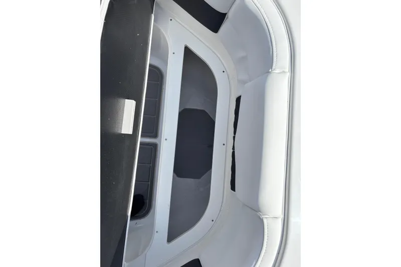 Slide: The Image of Interior view of 2026 Monterey Elite 25 OB boat, featuring sleek seating and storage area. - 33