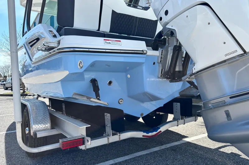 Slide: The Image of 2026 Monterey Elite 25 OB boat on trailer, showcasing sleek design and powerful outboard motor. - 4