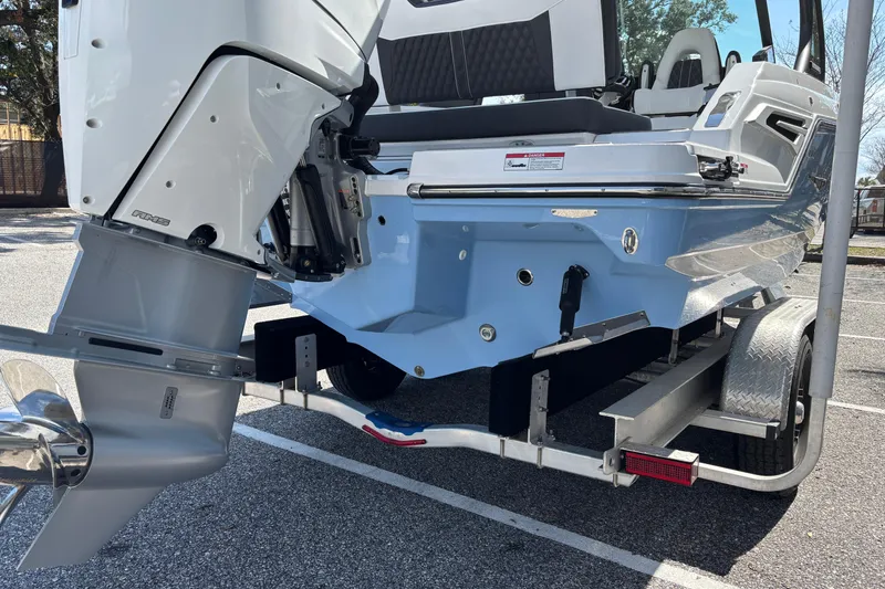 Slide: The Image of 2026 Monterey Elite 25 OB boat on trailer, showcasing outboard motor and sleek design. - 5