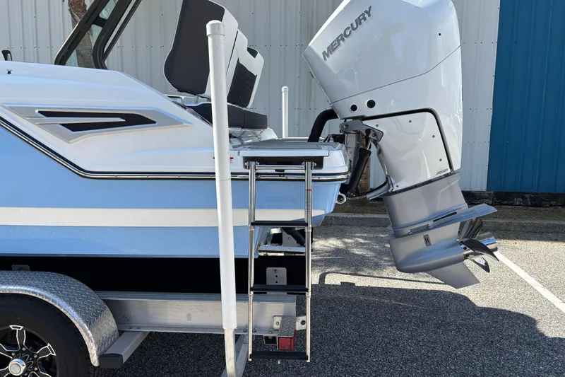 Slide: The Image of 2026 Monterey Elite 25 OB boat with Mercury outboard motor and ladder. - 9