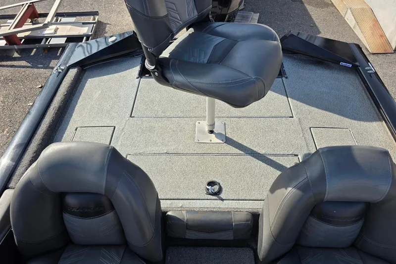 Slide: The Image of 2019 Tracker Pro Team 175 TXW boat interior with seating and carpeted deck. - 18