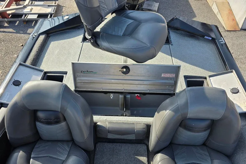 Slide: The Image of 2019 Tracker Pro Team 175 TXW boat interior with gray seating and storage compartments. - 19