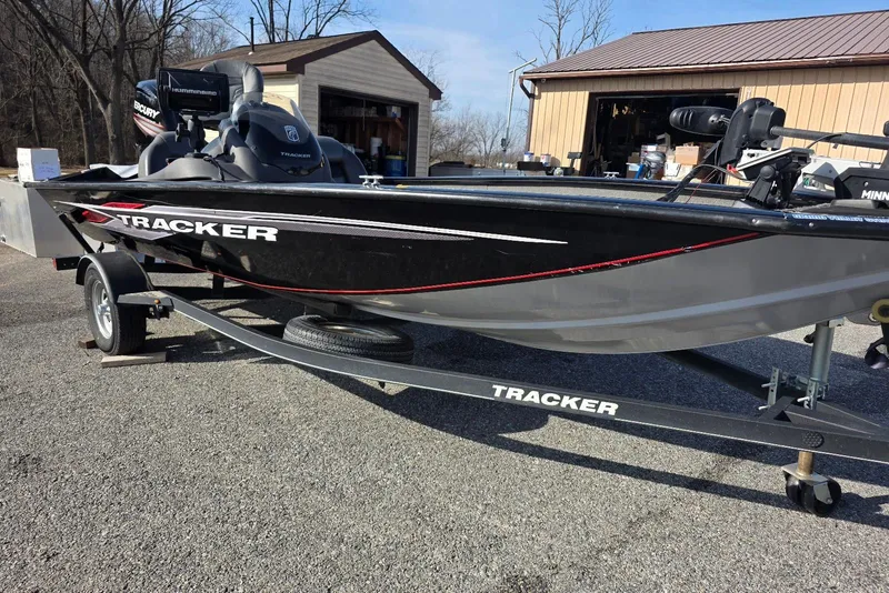 Slide: The Image of 2019 Tracker Pro Team 175 TXW boat on trailer, parked outdoors. - 2
