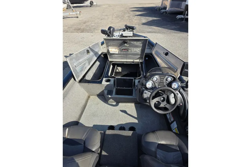 Slide: The Image of 2019 Tracker Pro Team 175 TXW boat interior with open storage compartments and steering console. - 8