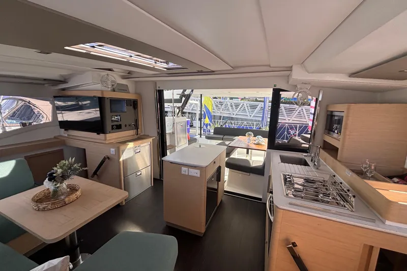 Slide: The Image of Luxurious interior of 2025 Fountaine Pajot 41 catamaran with modern kitchen and dining area. - 10