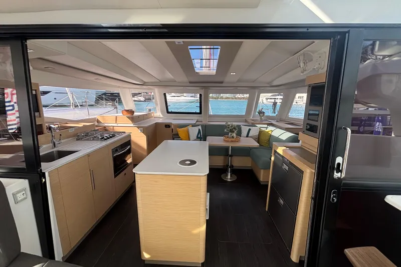 Slide: The Image of Modern interior of 2025 Fountaine Pajot 41 catamaran with kitchen and seating area. - 12