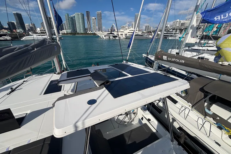 Slide: The Image of 2025 Fountaine Pajot 41 catamaran docked in a marina with city skyline backdrop. - 17