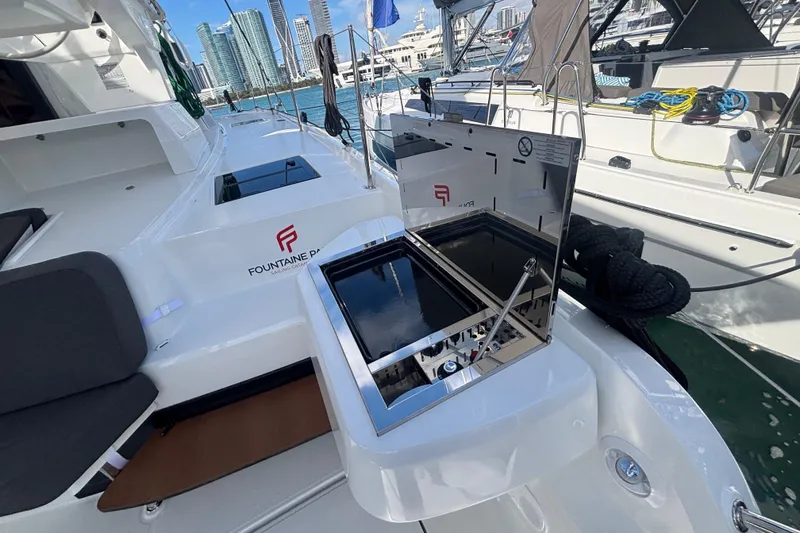Slide: The Image of 2025 Fountaine Pajot 41 yacht deck with grill, docked in a marina. - 23