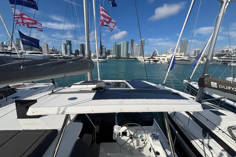 Slide: The Image of 2025 Fountaine Pajot 41 catamaran docked in marina with city skyline backdrop. - 40