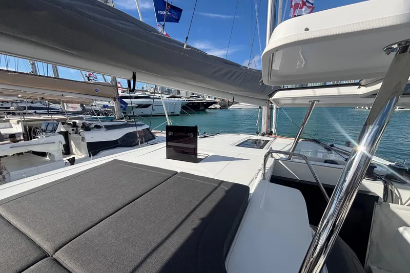 Slide: The Image of 2025 Fountaine Pajot 41 catamaran deck with sunbathing area and marina view. - 43