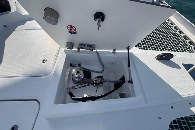 Slide: The Image of 2025 Fountaine Pajot 41 yacht deck with open storage compartment and winch. - 44