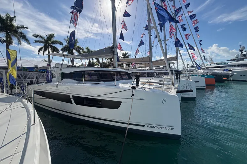 The Image of 2025 Fountaine Pajot 41 catamaran docked near a waterfront building. - 0