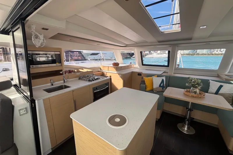 Slide: The Image of 2025 Fountaine Pajot 41 catamaran with modern seating and solar panels at a marina. - 13