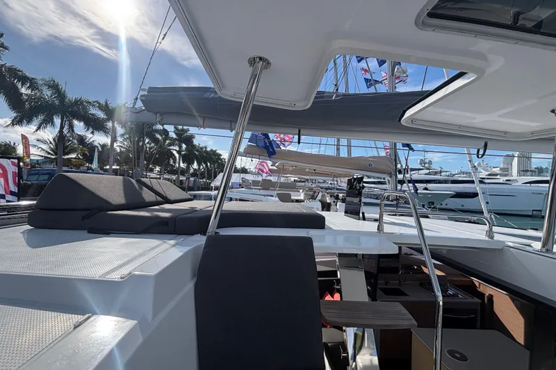 Slide: The Image of 2025 Fountaine Pajot 41 yacht cockpit with city skyline and marina view. - 39