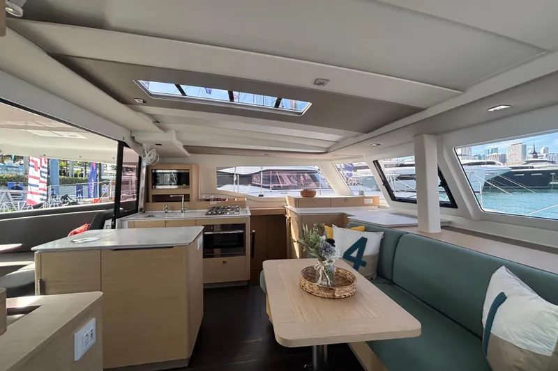 Slide: The Image of Helm of 2025 Fountaine Pajot 41 catamaran with city skyline in background. - 4