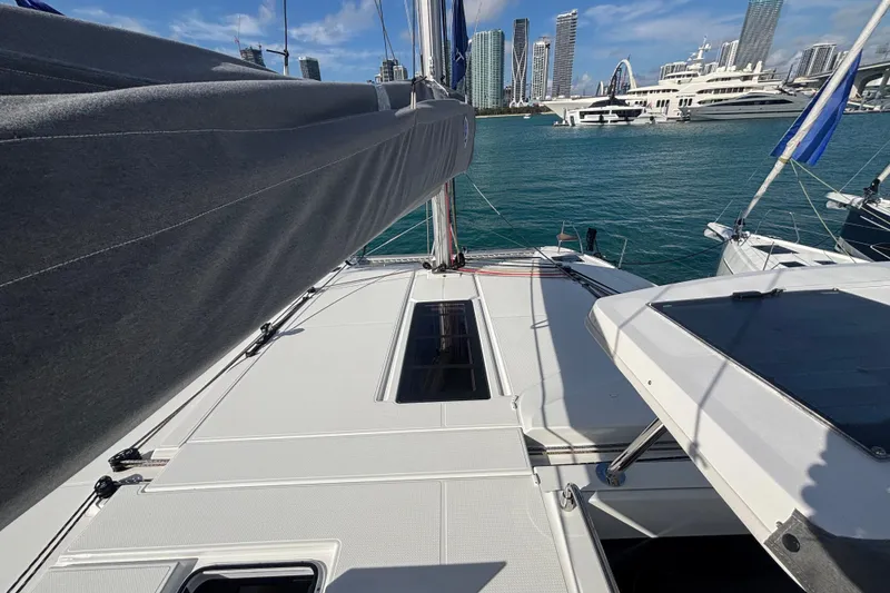 Slide: The Image of 2025 Fountaine Pajot 41 catamaran docked in marina with city skyline backdrop. - 42