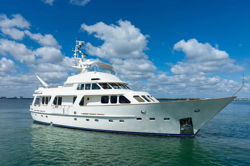 Slide: The Image of 1989 Moonen 85 Long Range Cruiser yacht on calm water under blue sky. - 1