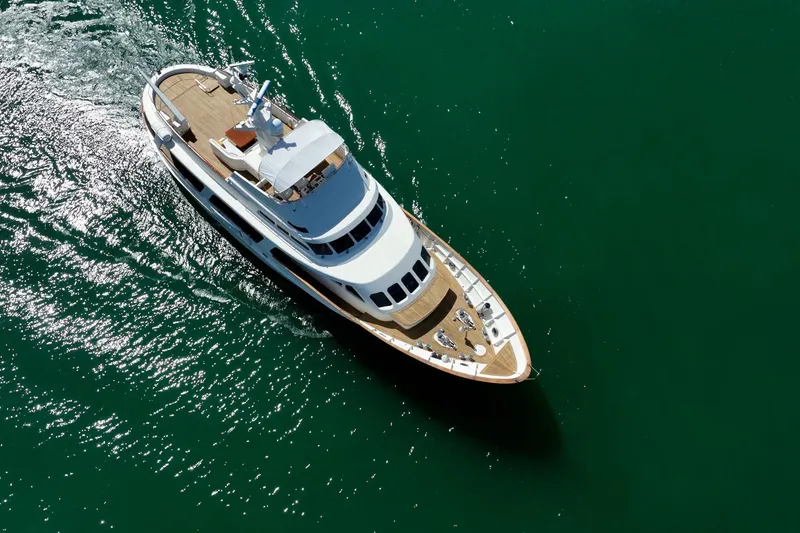 Slide: The Image of Aerial view of 1989 Moonen 85 Long Range Cruiser yacht on green water. - 15
