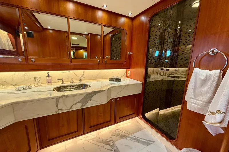 Slide: The Image of Luxurious bathroom on 1989 Moonen 85 Long Range Cruiser with marble countertop and wooden cabinetry. - 22