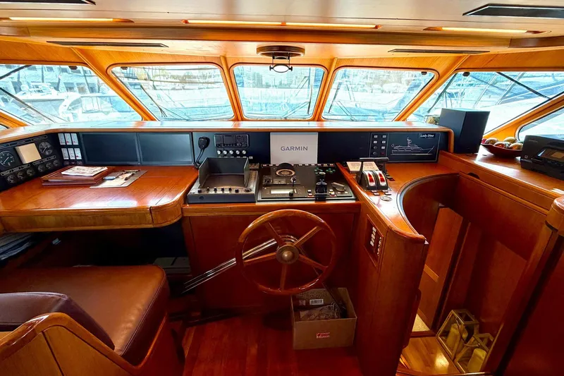 Slide: The Image of Interior helm of 1989 Moonen 85 Long Range Cruiser with wooden steering wheel and navigation equipment. - 27