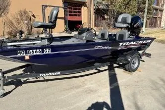 The Image of 2020 Tracker Pro 170 boat on trailer, parked outdoors in sunny setting. - 1