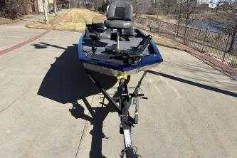 Slide: The Image of 2020 Tracker Pro 170 boat on trailer, parked on a driveway near a lake. - 5