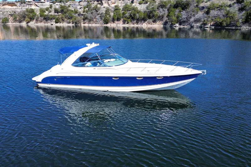 The Image of 2002 Formula 370 Super Sport boat on calm lake waters. - 1