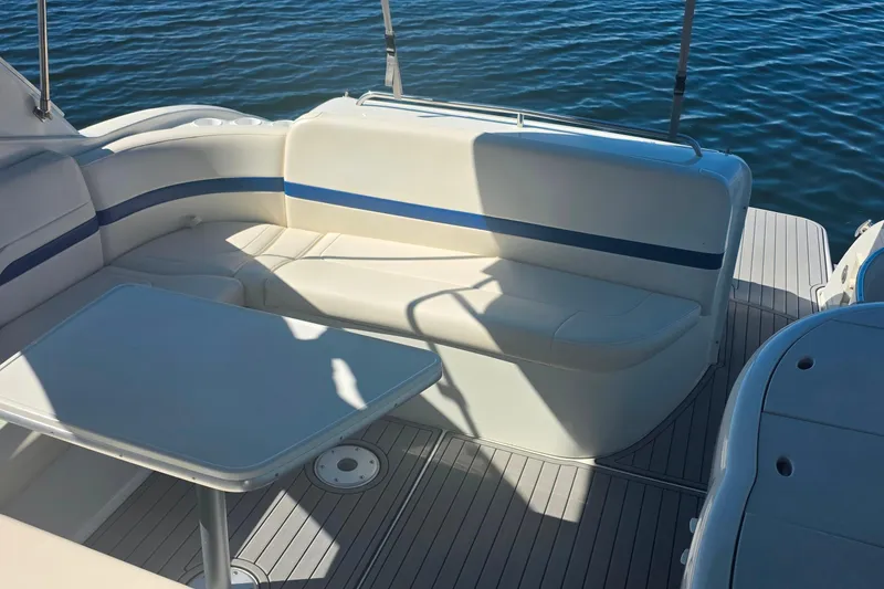 Slide: The Image of 2002 Formula 370 Super Sport boat interior with seating and table on water. - 10