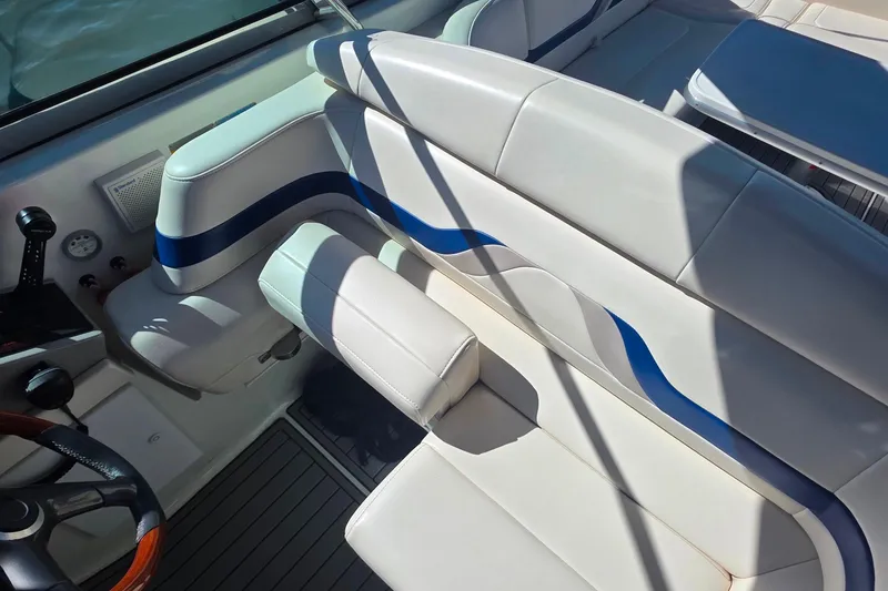 Slide: The Image of Interior of 2002 Formula 370 Super Sport boat with white and blue seating. - 18