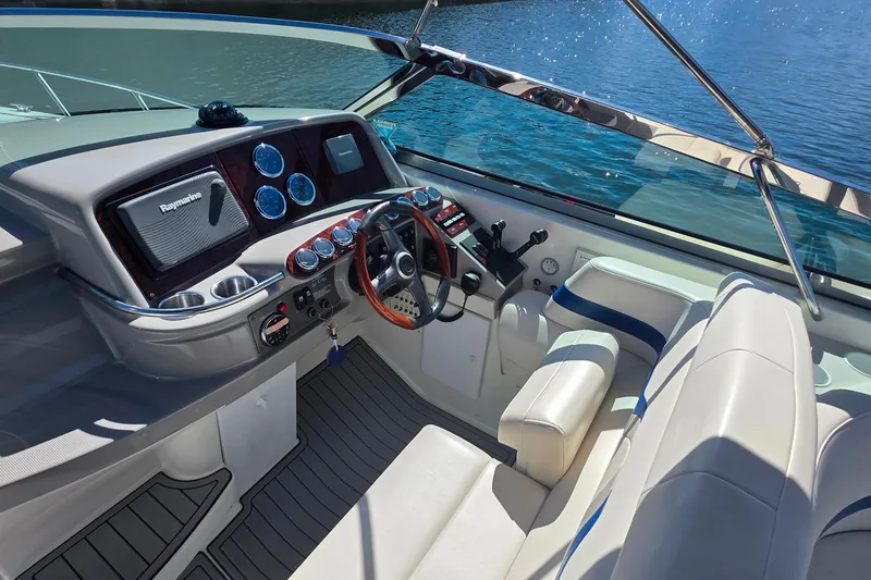 Slide: The Image of Cockpit of 2002 Formula 370 Super Sport boat with steering wheel and control panel. - 19