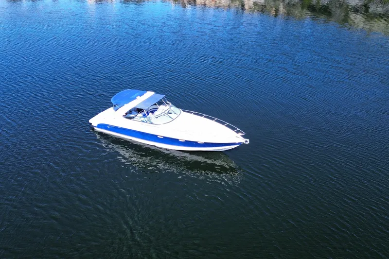 Slide: The Image of 2002 Formula 370 Super Sport boat on calm blue water. - 3