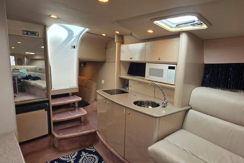 Slide: The Image of Interior of a 2002 Formula 370 Super Sport boat with kitchenette and seating area. - 33