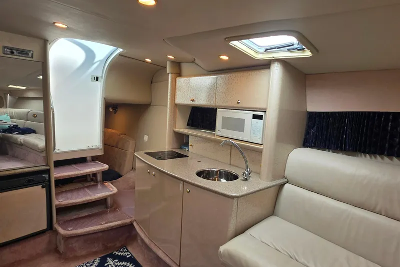 Slide: The Image of Interior of a 2002 Formula 370 Super Sport yacht with kitchenette and seating area. - 35