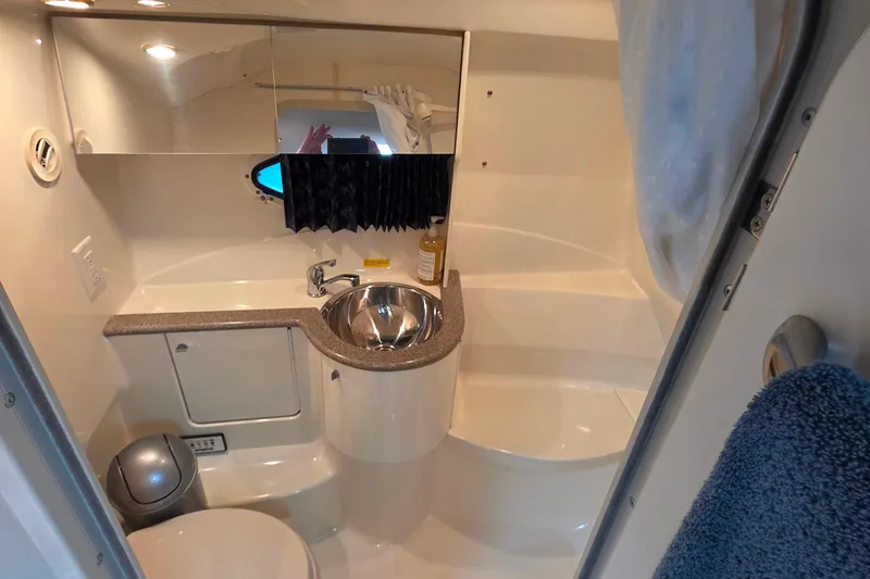 Slide: The Image of 2002 Formula 370 Super Sport boat bathroom with sink, mirror, and toilet. - 42