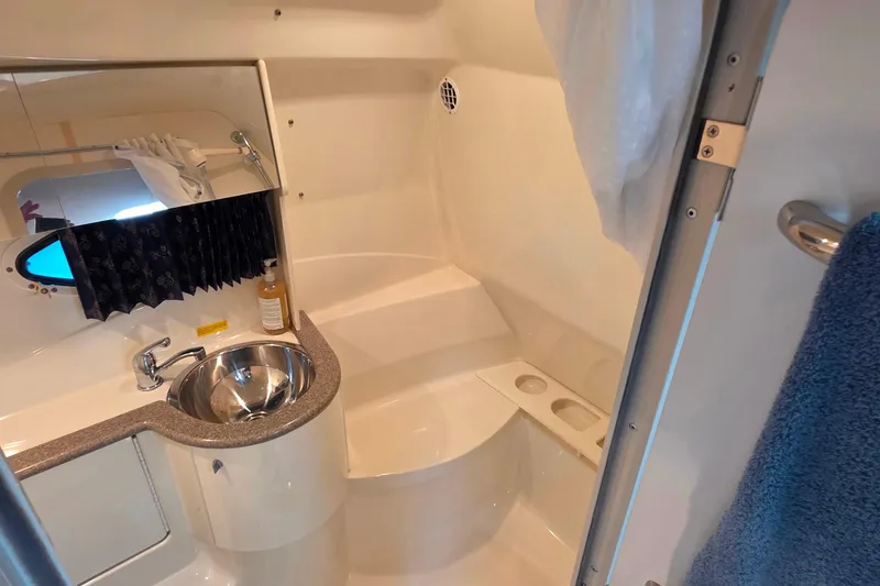 Slide: The Image of 2002 Formula 370 Super Sport boat bathroom with sink, mirror, and shower area. - 43
