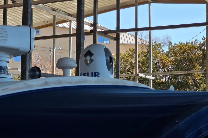 Slide: The Image of 2002 Formula 370 Super Sport boat with radar and satellite equipment in a covered dock. - 45