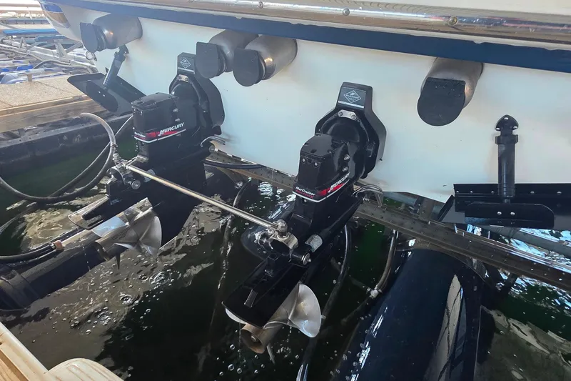 Slide: The Image of 2002 Formula 370 Super Sport boat with dual Mercury outboard motors in a marina. - 46