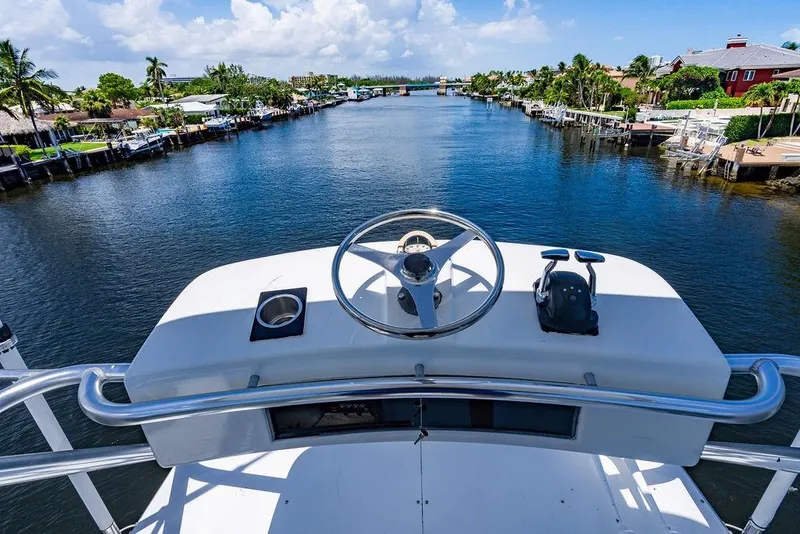 Slide: The Image of Helm view from 1998 Bertram 60 Convertible yacht on a scenic waterway. - 14