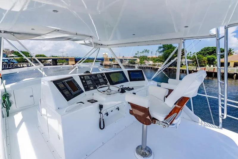Slide: The Image of 1998 Bertram 60 Convertible yacht helm with navigation equipment and captain's chair, dockside view. - 15