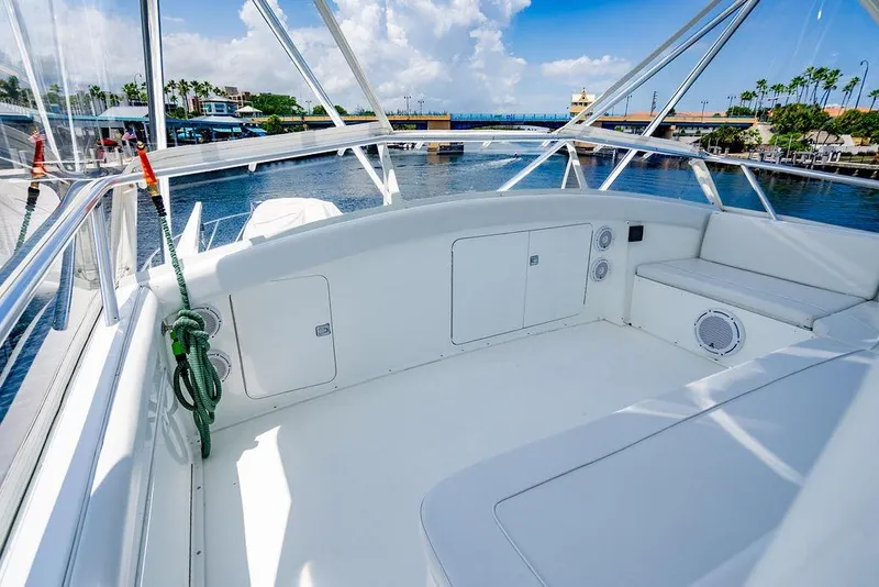 Slide: The Image of 1998 Bertram 60 Convertible yacht deck with marina view, clear skies, and calm waters. - 16